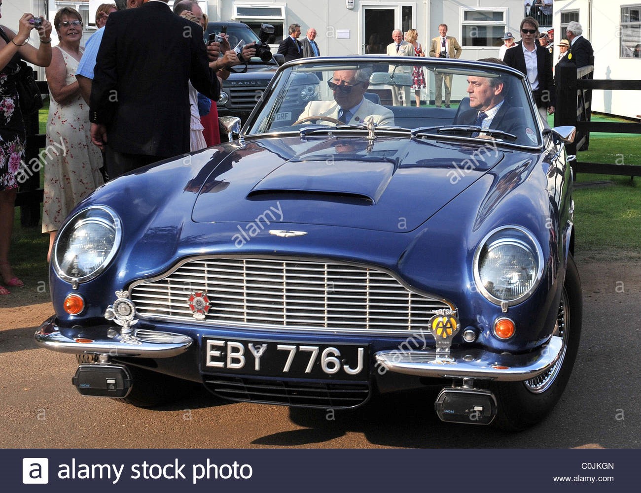 Prince Charles drives away in his wine powered Aston Martin Cartier International Polo tournament held at the Guards Polo Club.
