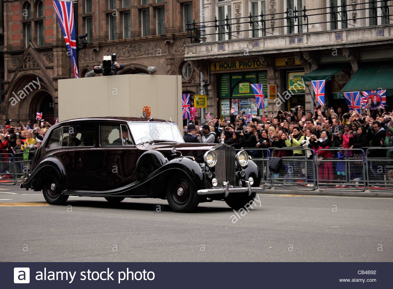 Prince Charles and the Duchess of Cornwall being driven in Rolls Royce.