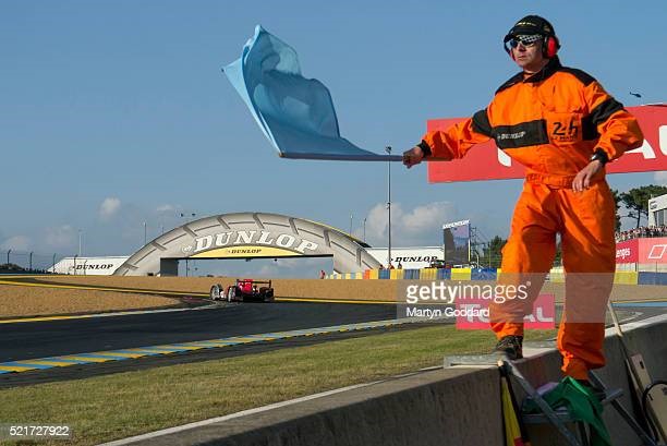 Flag marshal waving blue flag at the approach to Dunlop chicane. 2014 24 Hours of Le Mans. 