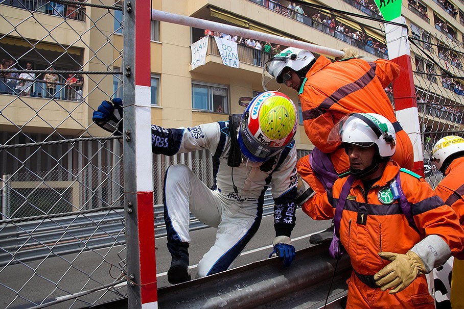 Webber jumping over the barrier after retiring with exhaust problems at Monaco in July 2006. 