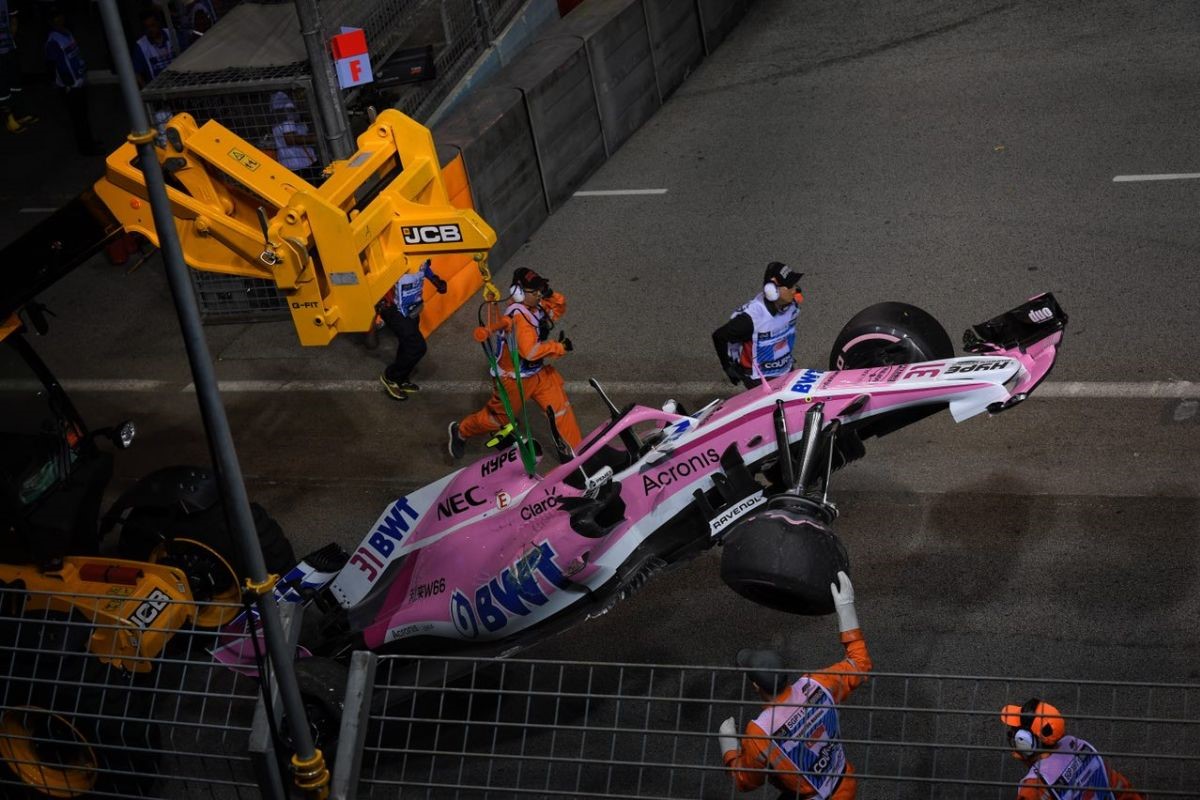 2018 Singapore Grand Prix. A crane lifts Esteban Ocon's damaged Force India from the track after he crashed with teammate Sergio Perez.