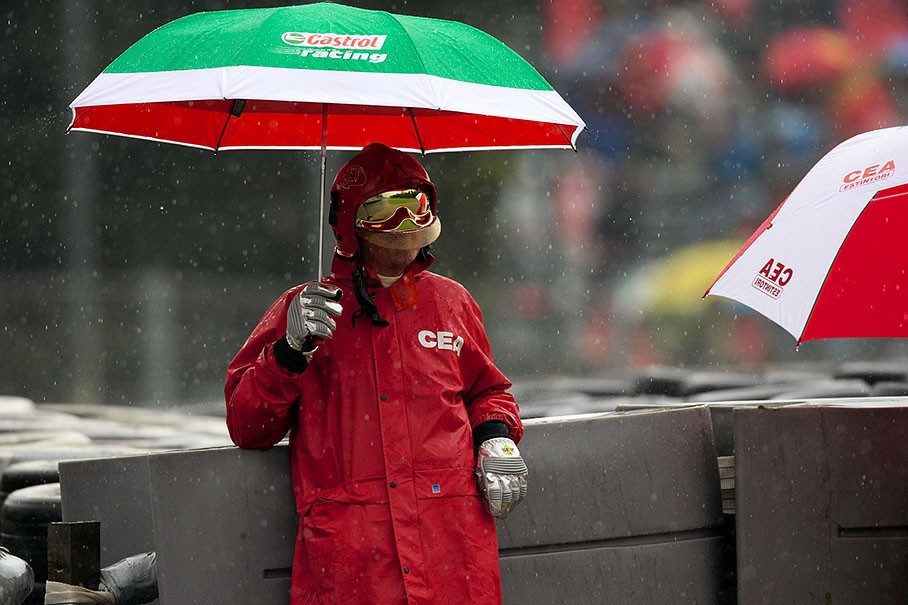 A fire marshal under his umbrella during a rain-suspended session at Monza in 2008. 