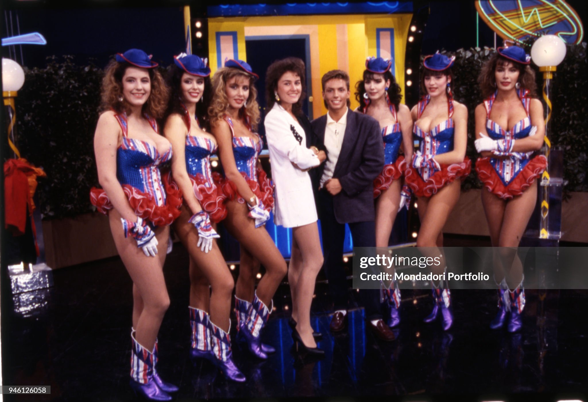 Lory Del Santo (Loredana Del Santo) and Piersilvio Berlusconi posing among the Fast Food girls of the famous TV comic show 'Drive In' in Milan, Italy, in 1986. 