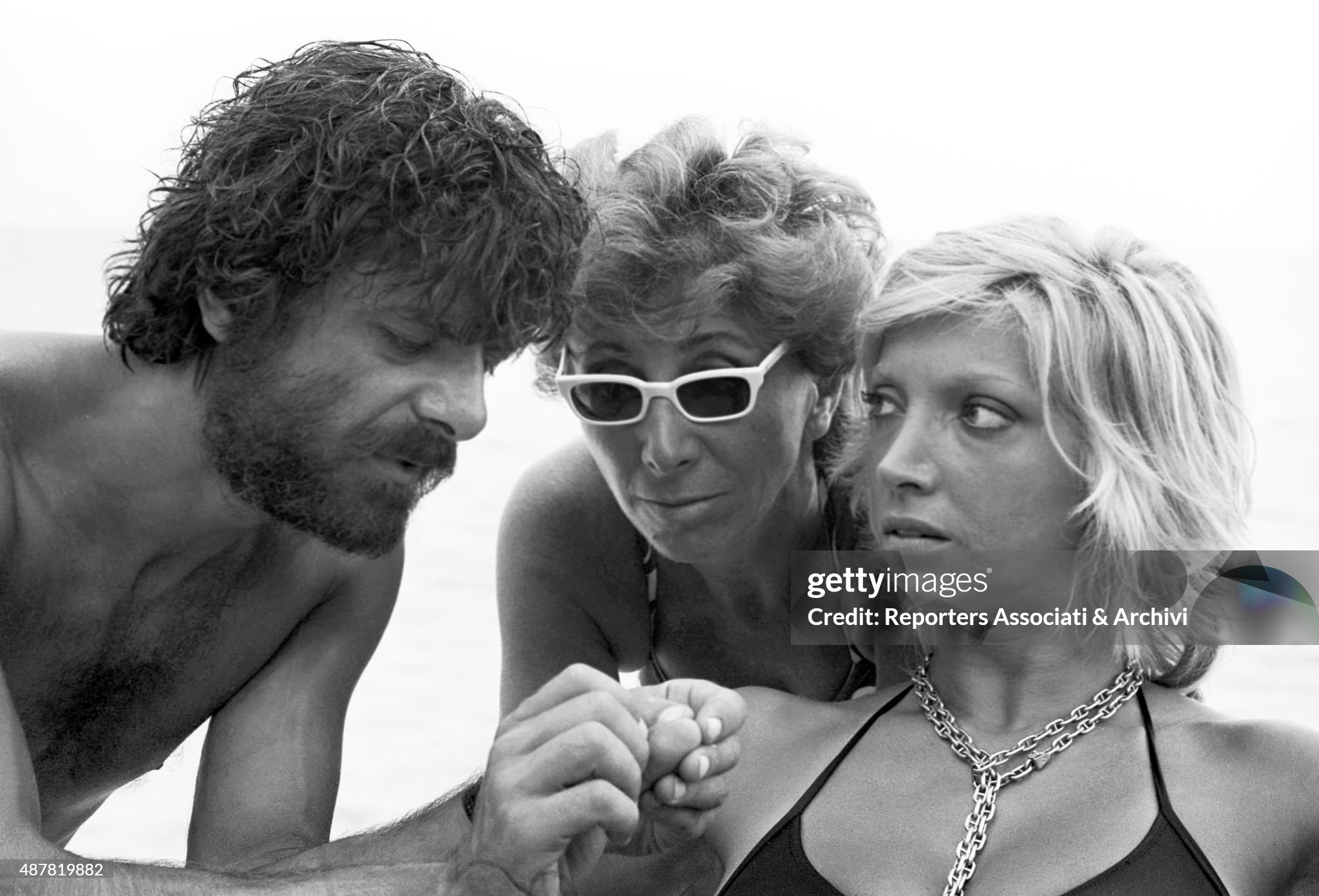 Italian director and scriptwriter Lina Wertmuller, Italian actor, director and scriptwriter Giancarlo Giannini and Italian actress Mariangela Melato discussing on the set of the film Swept away in Italy in 1974. 