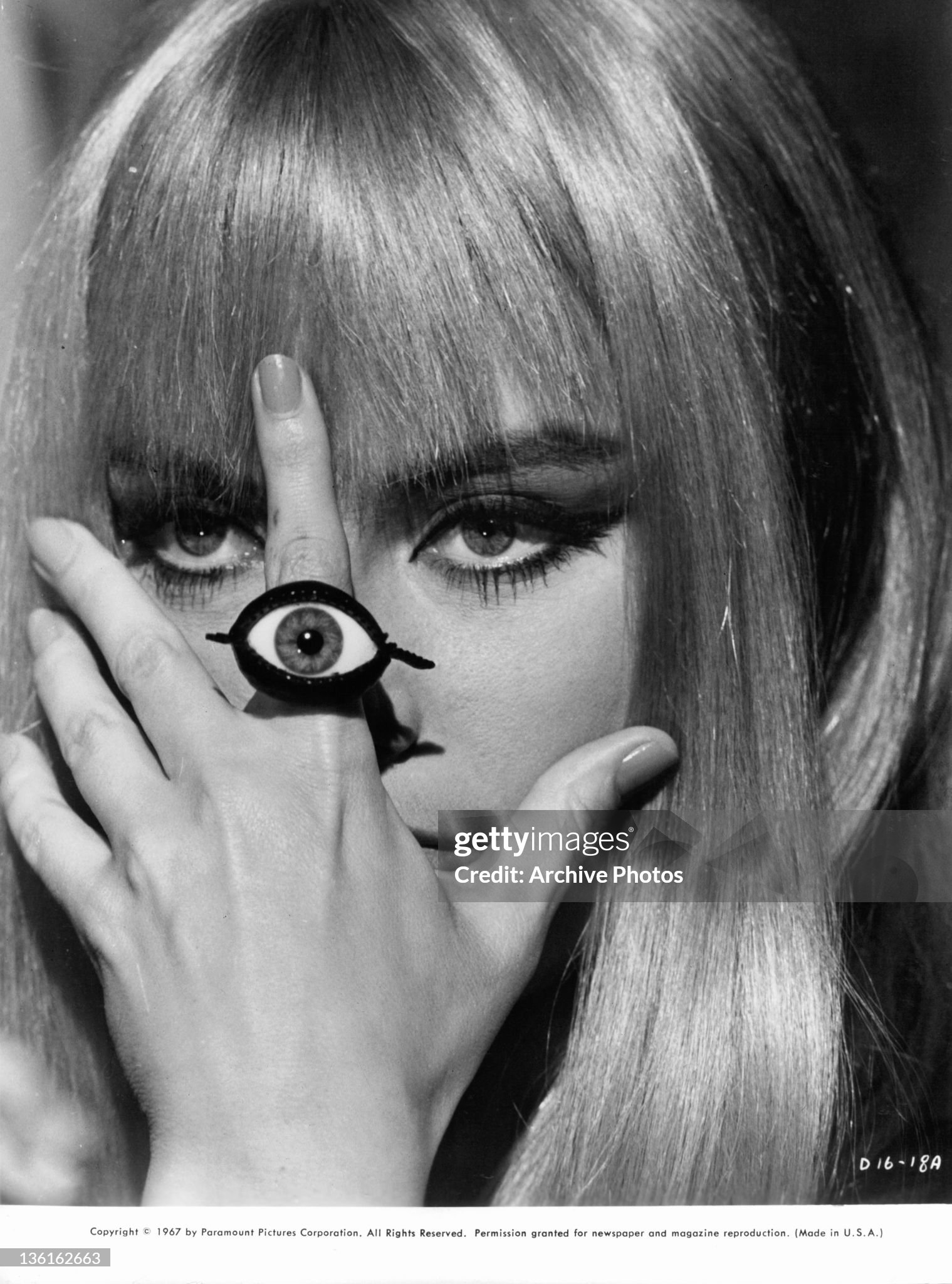 Marisa Mell covers her face with her hand in a scene from the film 'Danger: Diabolik' in 1968. 
