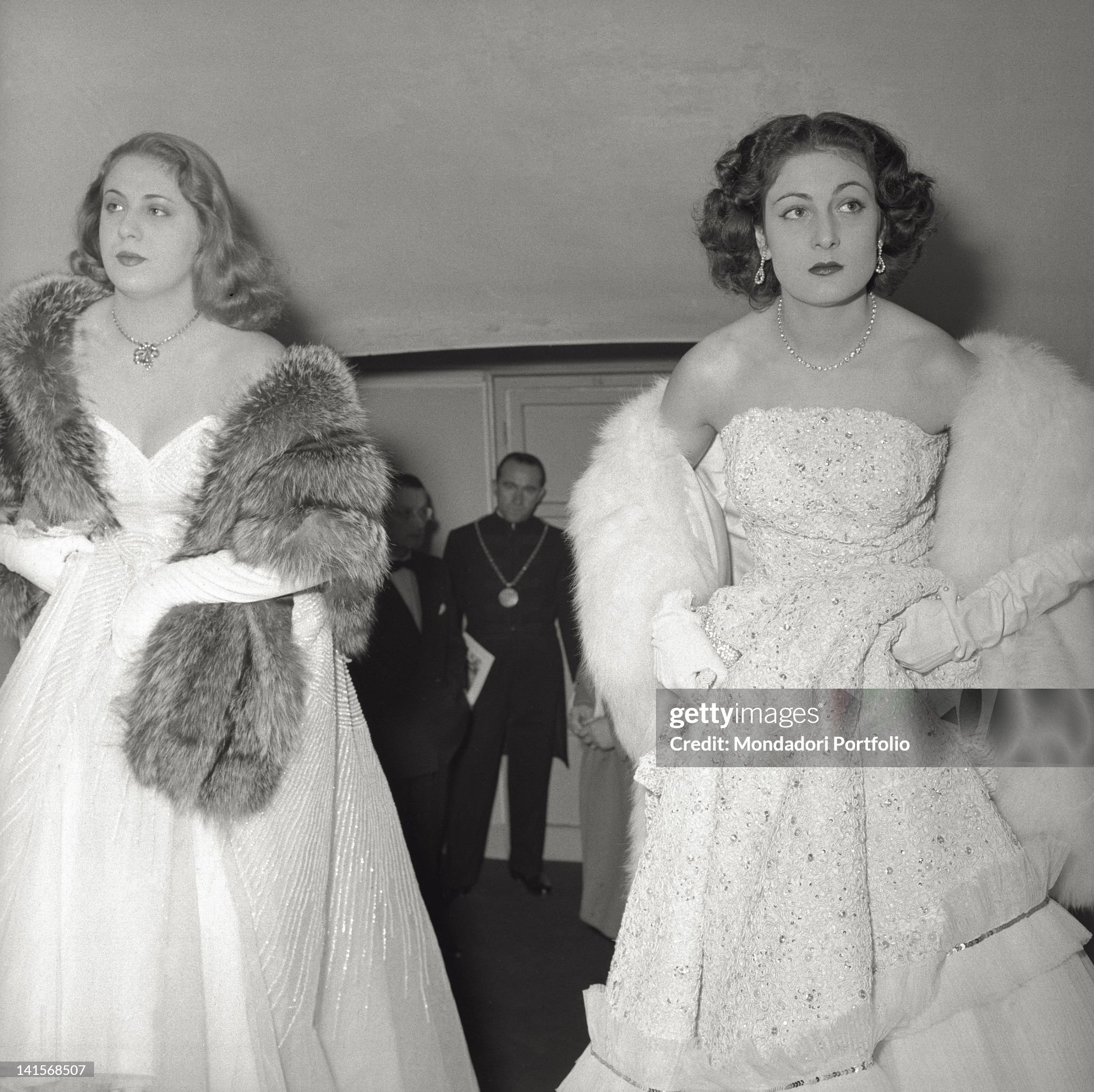 Two elegantly dressed ladies are among the audience of the Teatro alla Scala during the season inauguration night. The 'Norma' by Vincenzo Bellini shall be the opera performed on this occasion; it shall be sung by Maria Callas, Mario Del Monaco and Giulietta Simionato. Milan, December 07, 1955. 