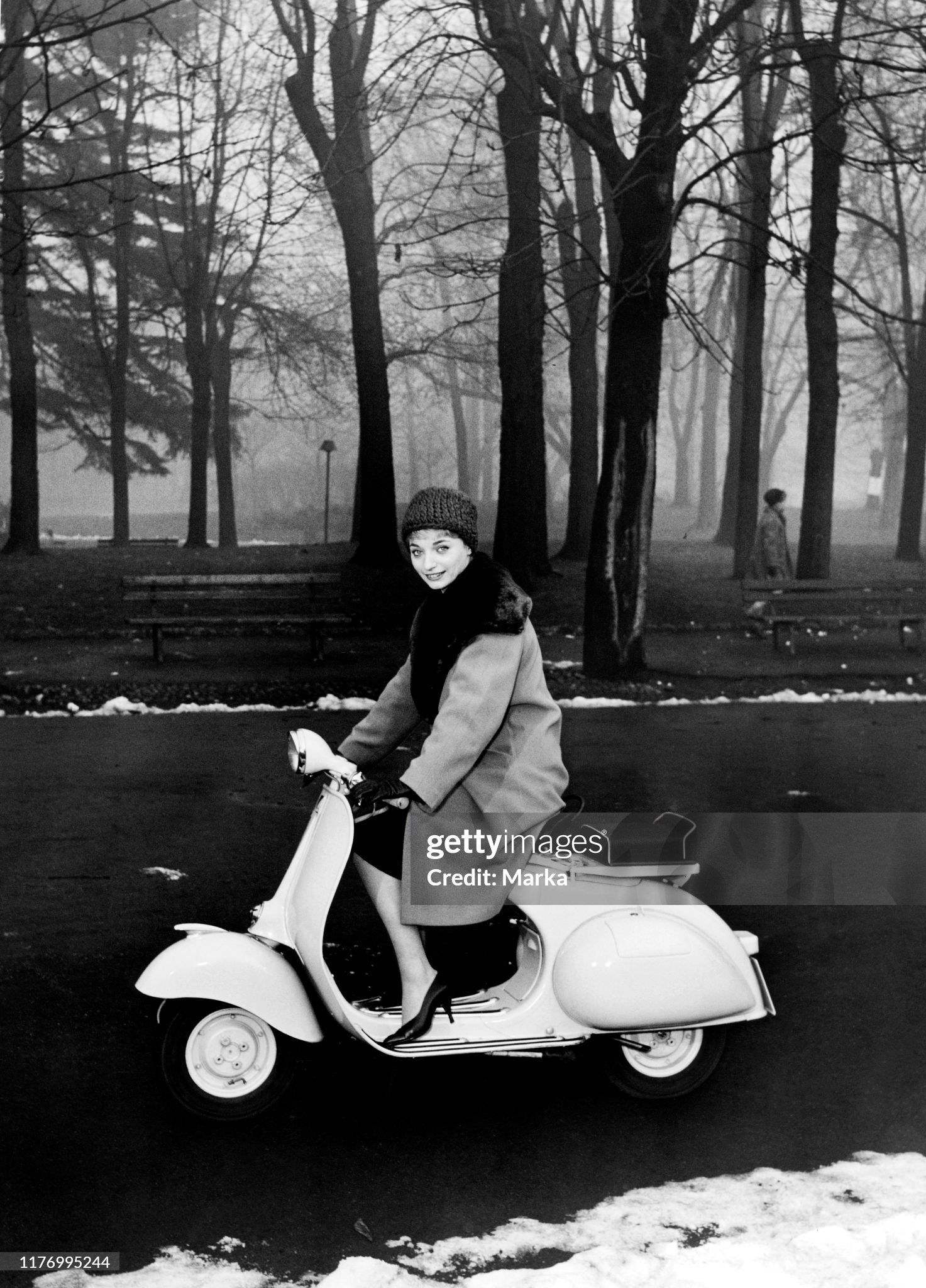 A girl with a vespa at the park in Milan, Italy, in 1958. 