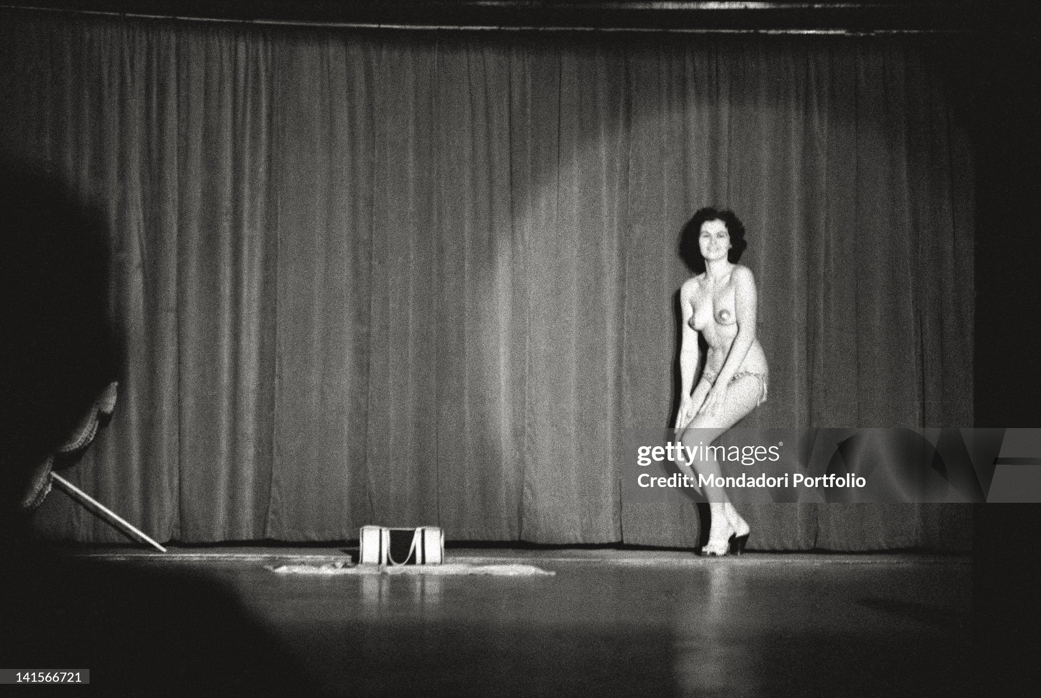 Stripteaser ending her performance in a nightclub in Milan in 1960s.