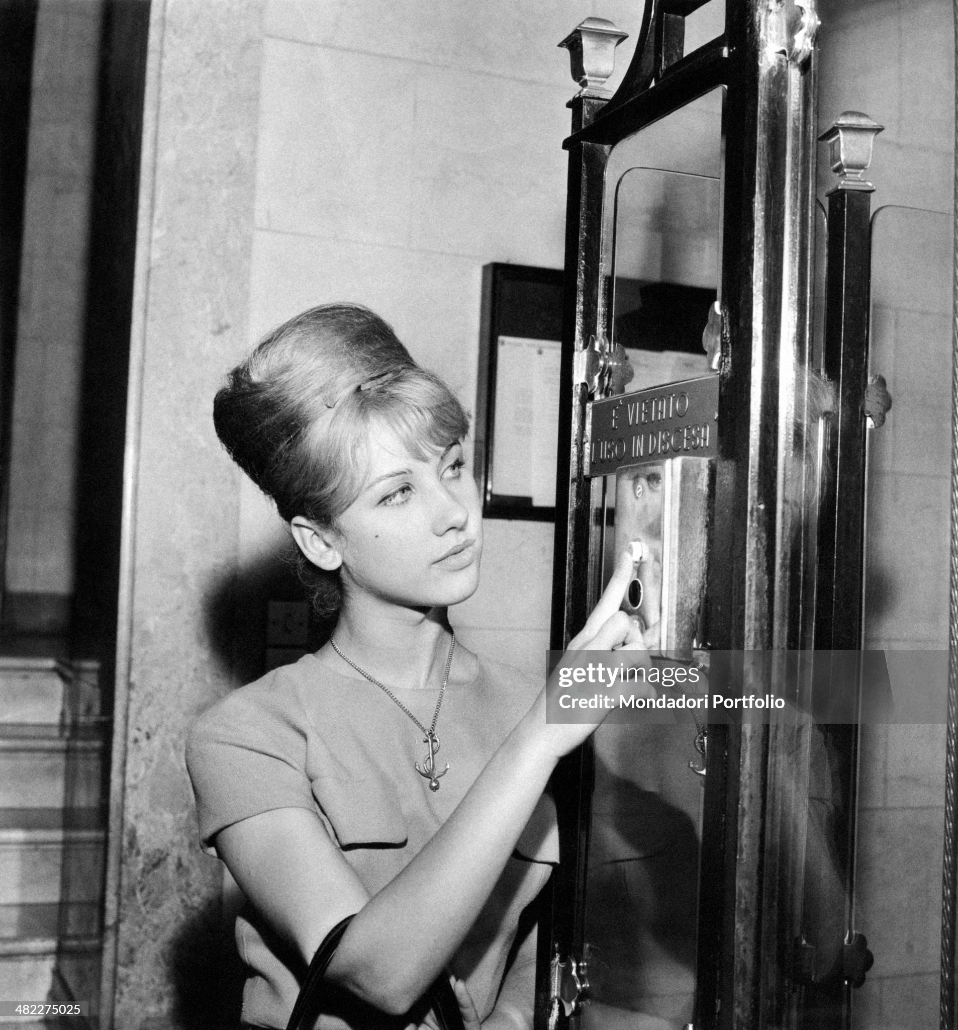 A girl pushing the lift button at publishing house Mondadori headquarters in Milan in October 1961. 