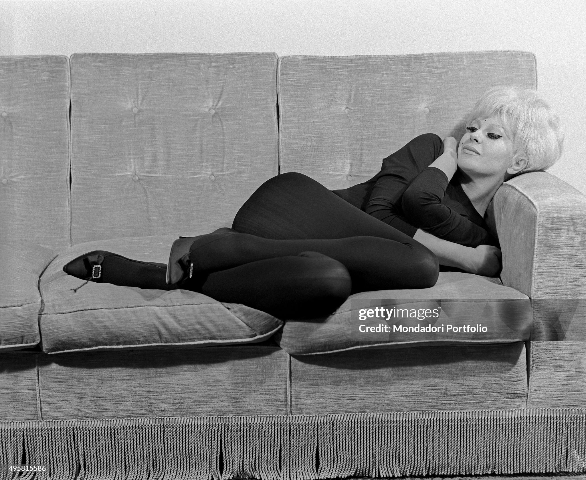 Italian actress Franca Rame lying on a sofa in Milan in 1962.