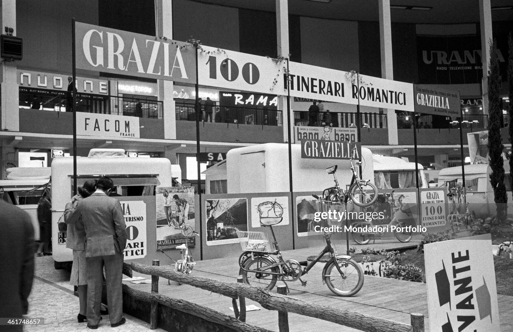 Interested visitors at the Grazia stand at the Fiera Milano where is shown the innovative folding bike designed by Rinaldo Donzelli in Milan, Italy, in April 1963.