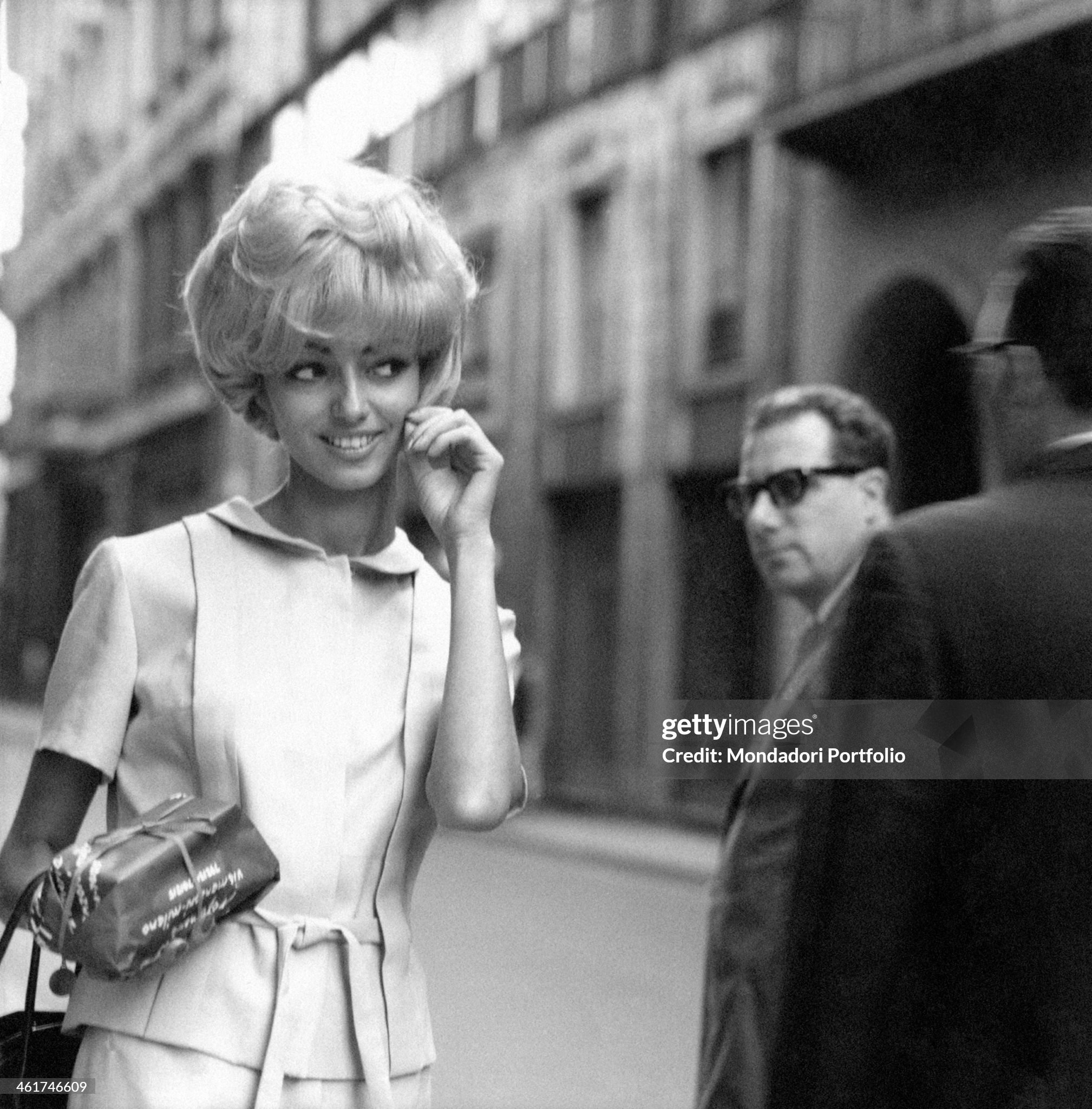 A proud girl showing off her blonde dyed hair in via Monte Napoleone in Milan in 1965.