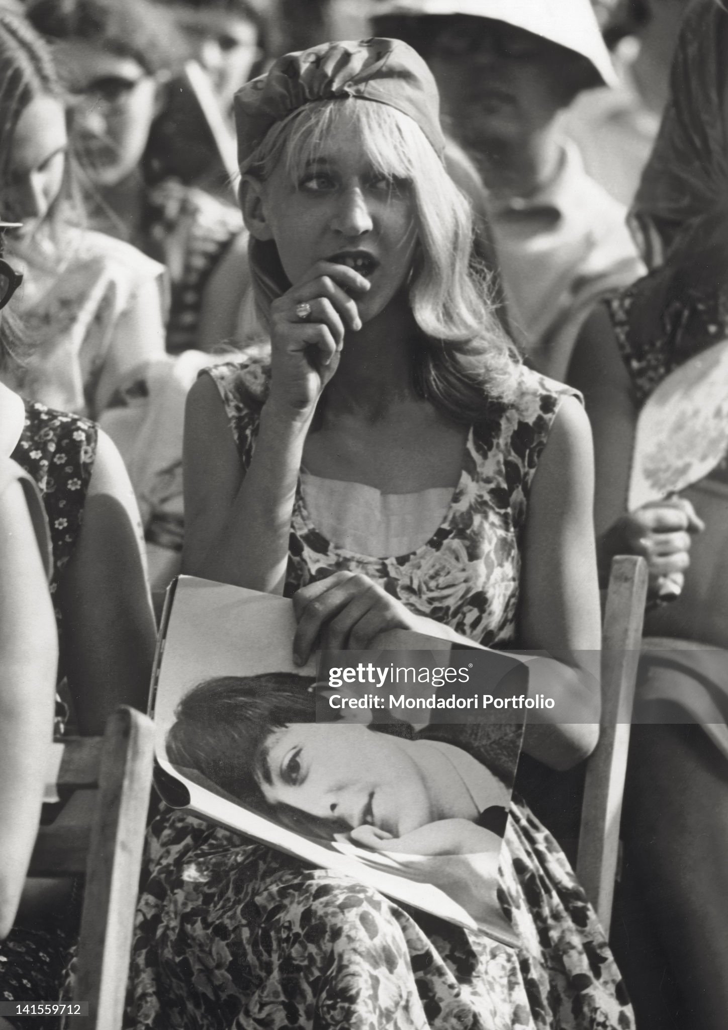 A female spectator with a picture of Paul McCartney at the Beatles concert held at the Velodromo Vigorelli in Milan on 24 June 1965. 