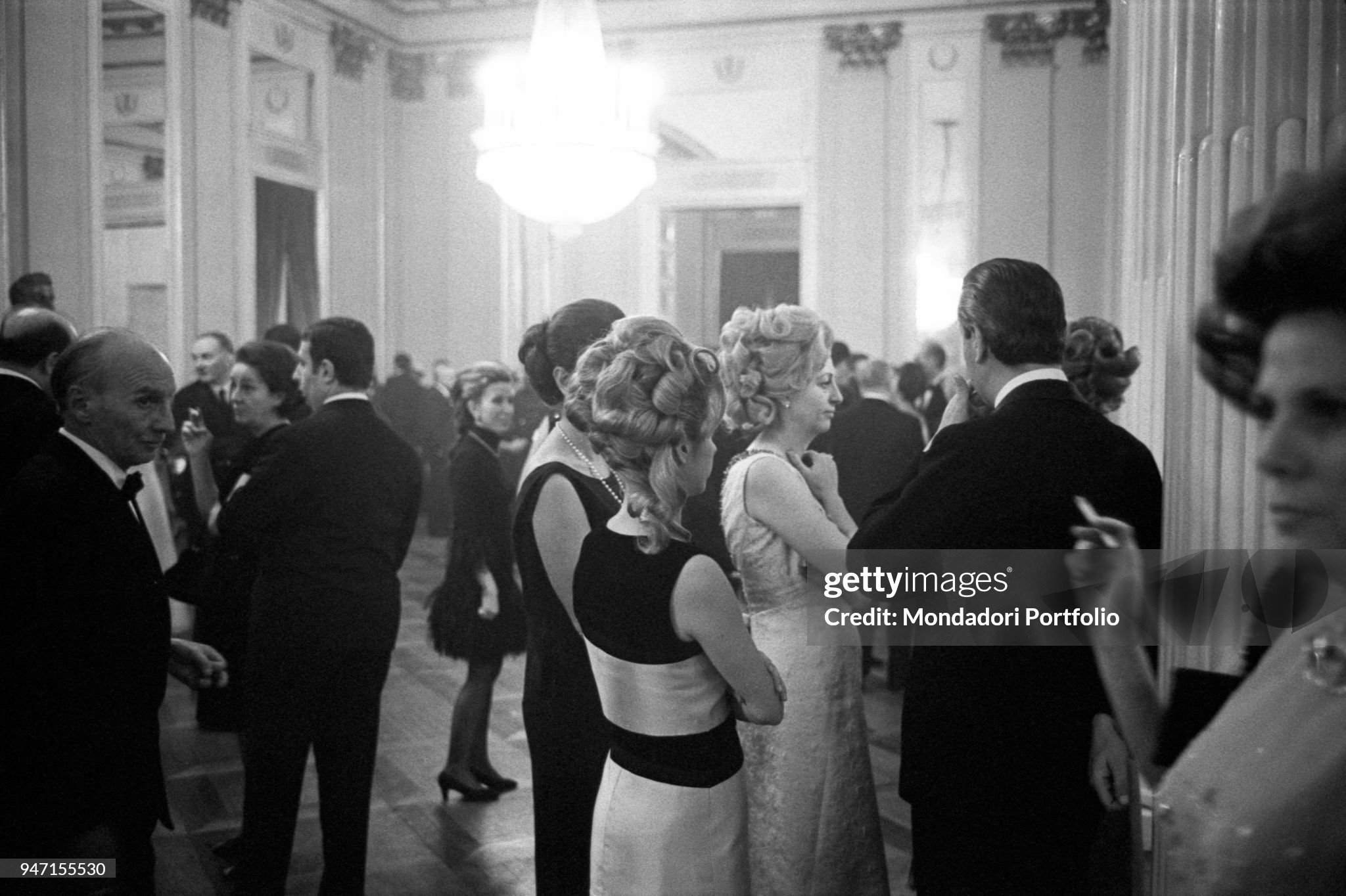 Some spectators waiting for the start of the opening night in the foyer of La Scala in Milan on 07 December 1968, while outside violent protests are occurring. 
