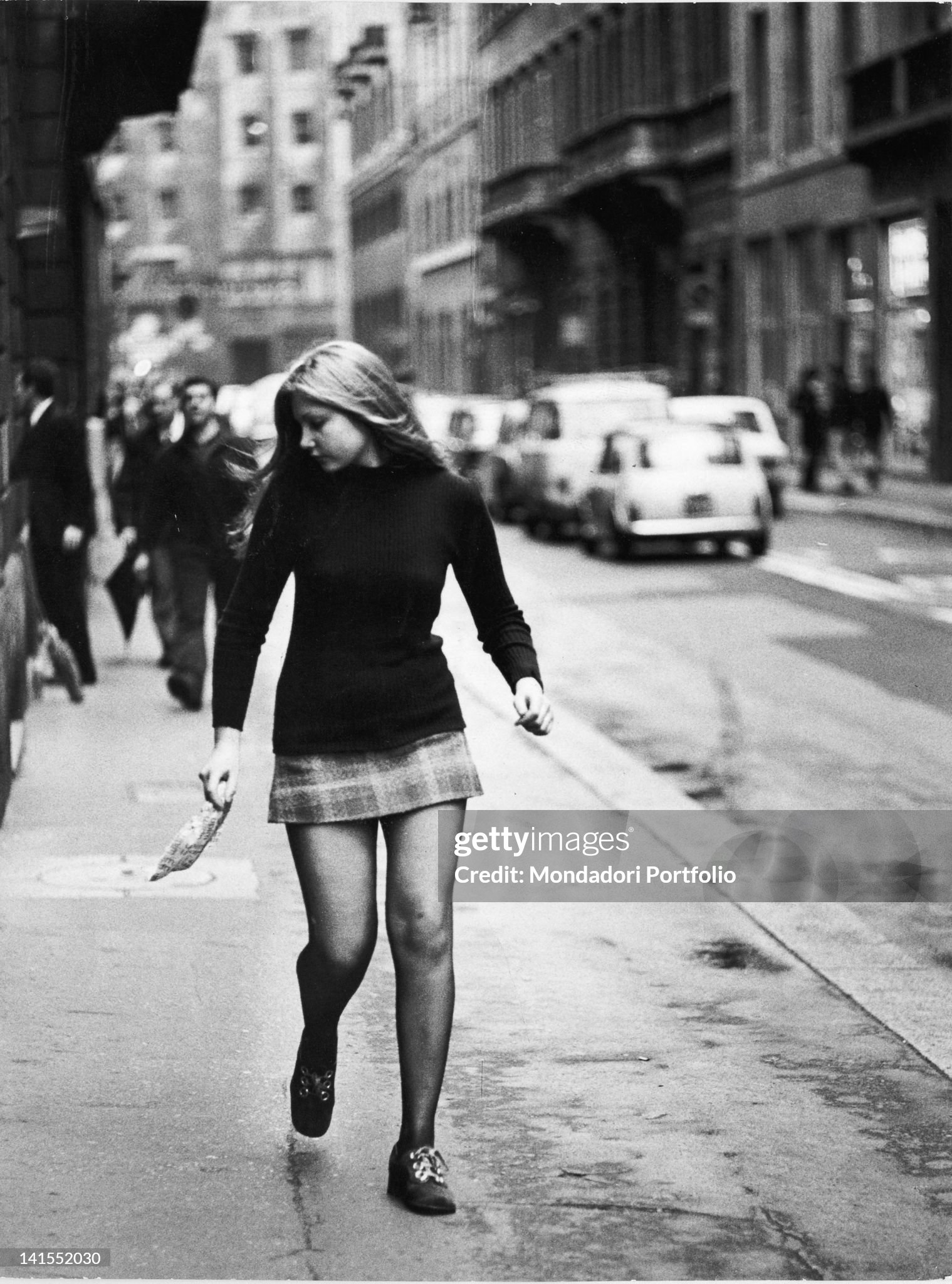 An Italian girl walking down the street in a miniskirt in Milan in 1971. 