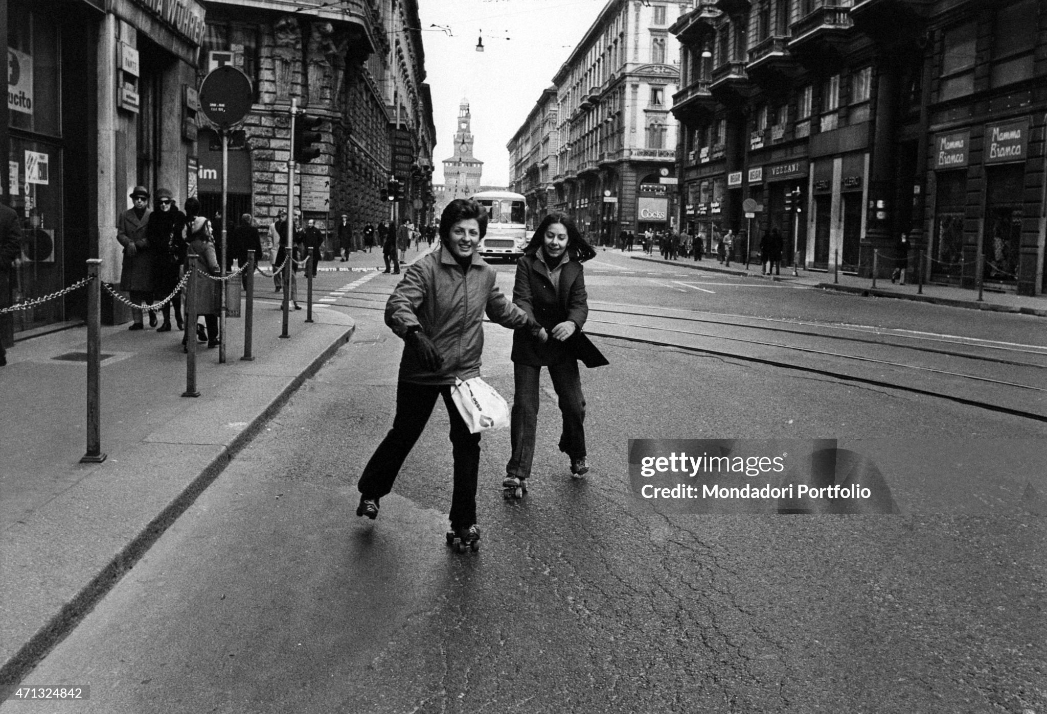 Two girls skating along via Dante during the first Italian walking Sunday due to the oil crisis in Milan on 02 December 1973. 