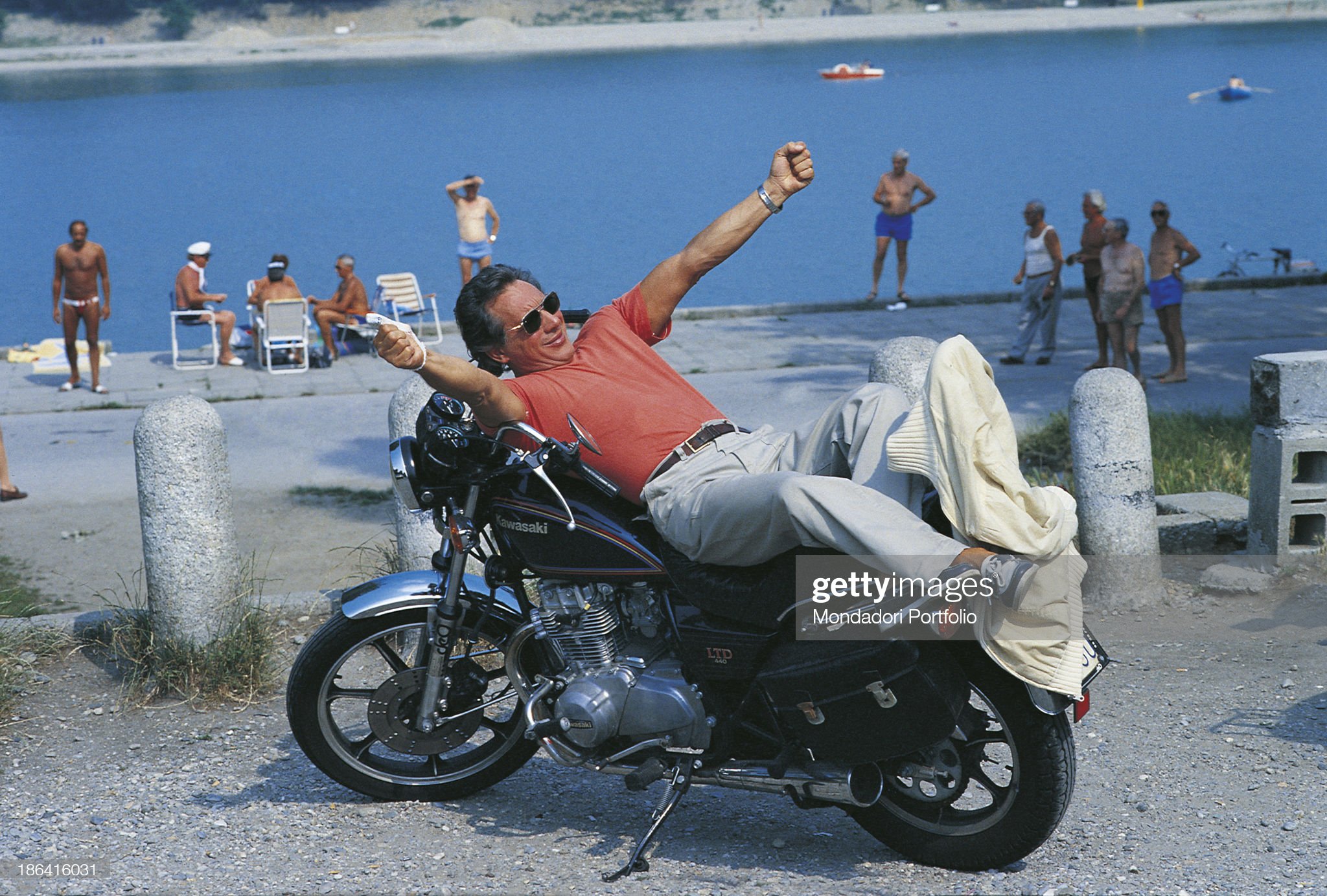 Enzo Jannacci lying on a motorbike in Sanremo in 1991.