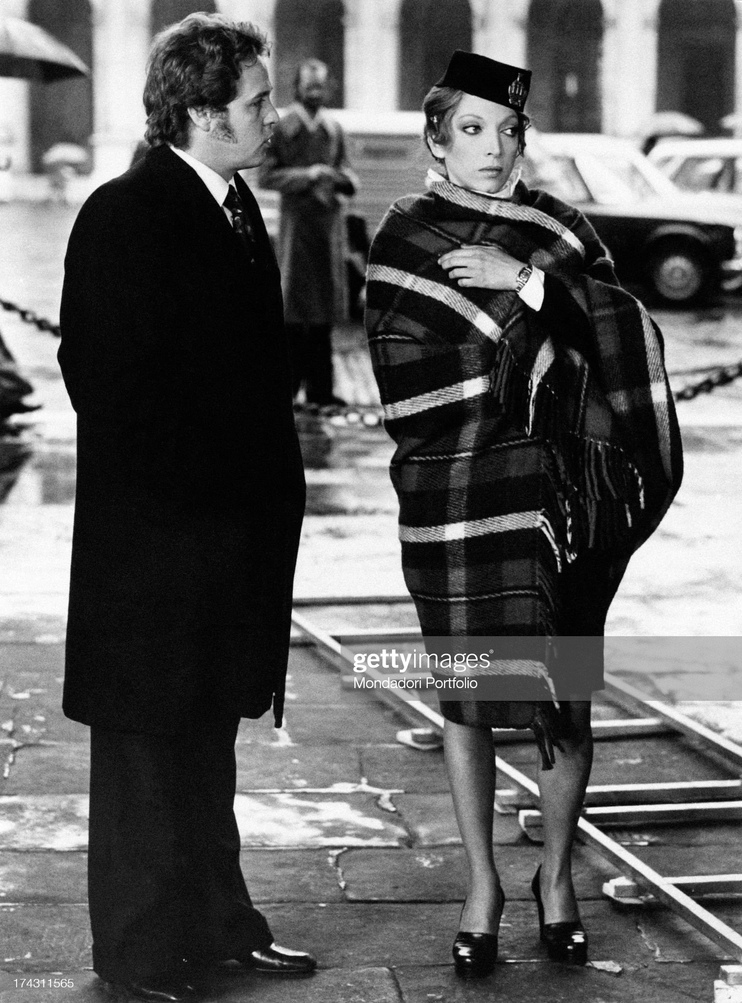 Italian actor and stand-up comedian Renato Pozzetto talking to Italian actress Mariangela Melato wrapped in a blanket on the set of the film Policewoman at Bergamo, Italy, in 1974. 