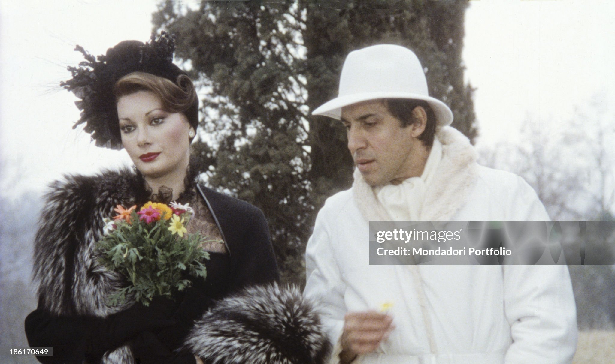 Italian actor, singer and songwriter Adriano Celentano giving some flowers to French-born Italian actress Edwige Fenech in the film Ace in Italy in 1981. 