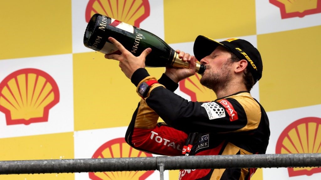 Romain Grosjean drinking champagne on the podium in 2015.