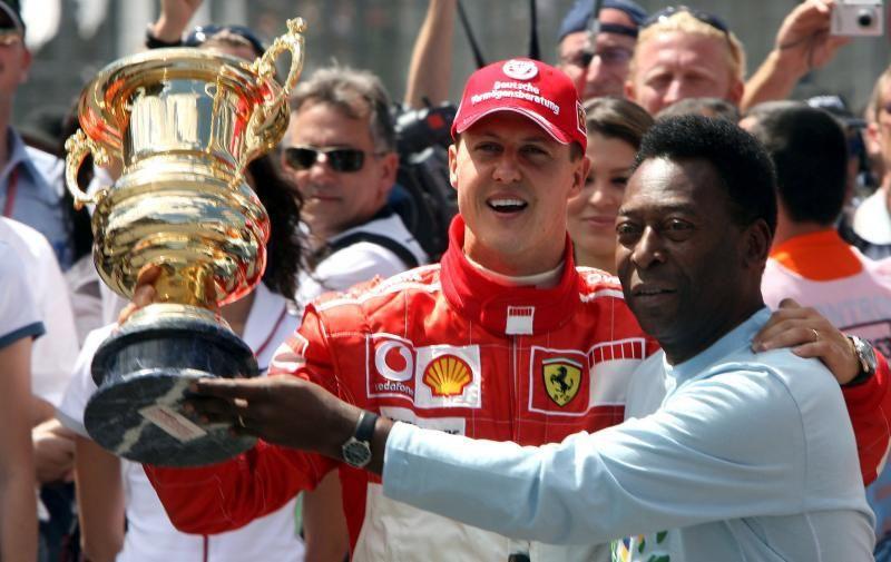 Michael Schumacher being presented a lifetime achievement award by Pelé.