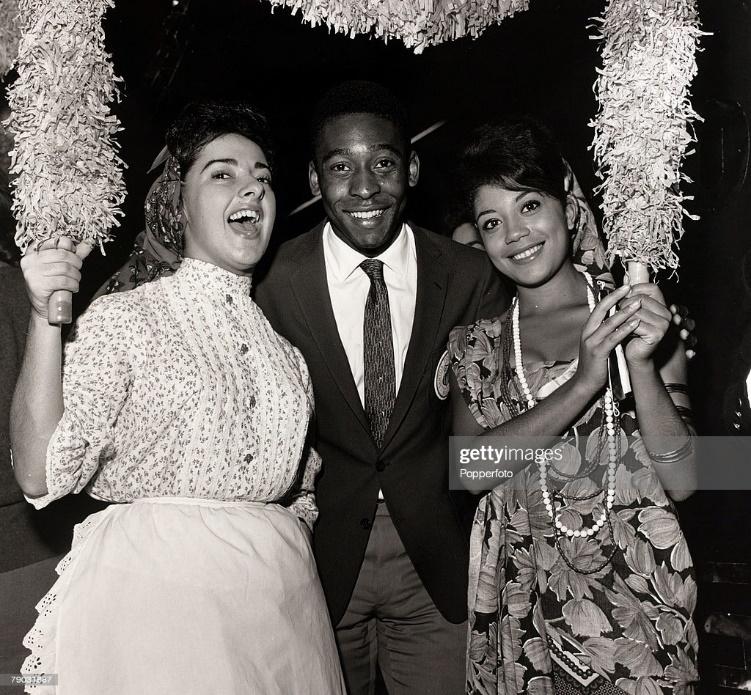 Brazil's Pele is pictured in 1962 with two young women at a function attended by the Santos team.