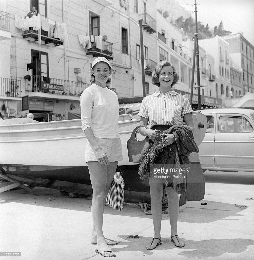 The actress Ingrid Bergman and her daughter Pia Lindstrom in a pose smiling near the pier. Capri, 1957.