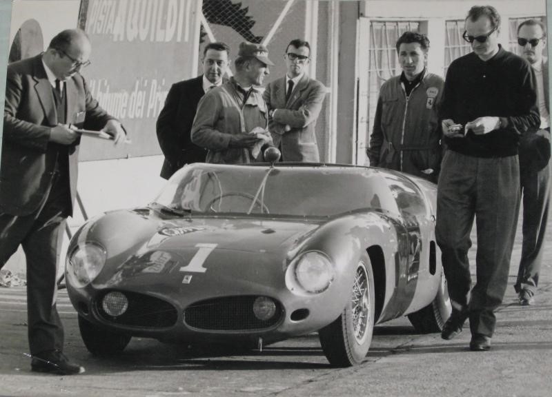 Testing Ferrari 246 at Monza in 1961, possibly 14 March, when it was tested with Richie Ginther (he may not be in this picture). It is the 1961 Ferrari 246/196 SP s/n 0790. People are from left: Carlo Chiti (with papers), Adelmo Marchetti (engineering hat), Ener Vecchi (if he is here, it may be the one with Shell mark on his working habit), Romolo Tavoni (dark sweater, glasses, radio to the right in front).
