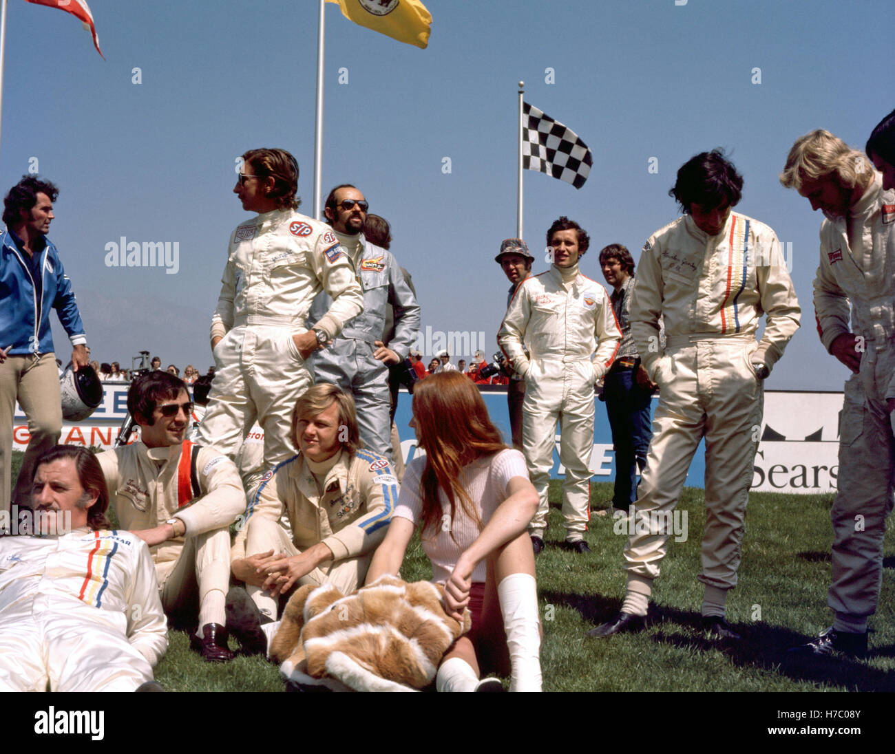 Graham Hill, Jo Siffert, Ronnie Peterson, Henri Pescarolo, Jacky Ickx and a girl at the Questor Grand Prix at the Ontario Motor Speedway in California, USA, on 28 March 1971. 