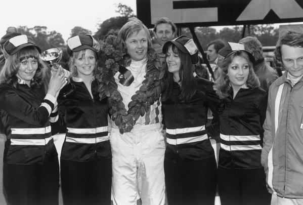 Oulton Park, England, 16th September 1972. Ronnie Peterson (March 722 - Ford BDA), 1st position, with Niki Lauda (March 722 - Ford BDF), 2nd position, on the podium with the sponsor girls