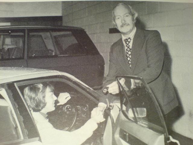 Colin Chapman hands over the keys to Ronnie Peterson for his new company car, a Lotus Elite, in 1974.