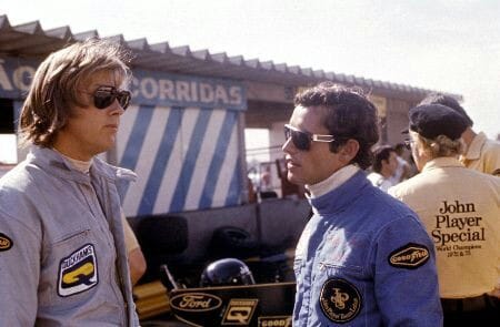 Ronnie Peterson and Jacky Ickx, Colin Chapman of shoulders.
