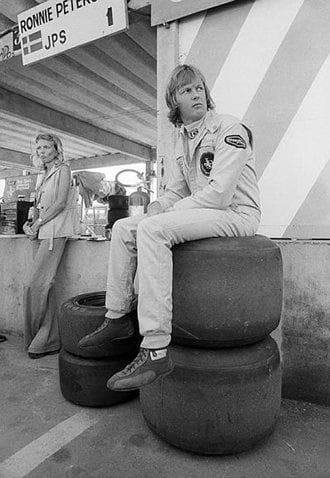 Sixth placed Ronnie Peterson, Lotus, sits on a tyre stack in the pits with his wife Barbro in the background at the Brazilian Grand Prix in Interlagos, Sao Paulo, on 27 January 1974.