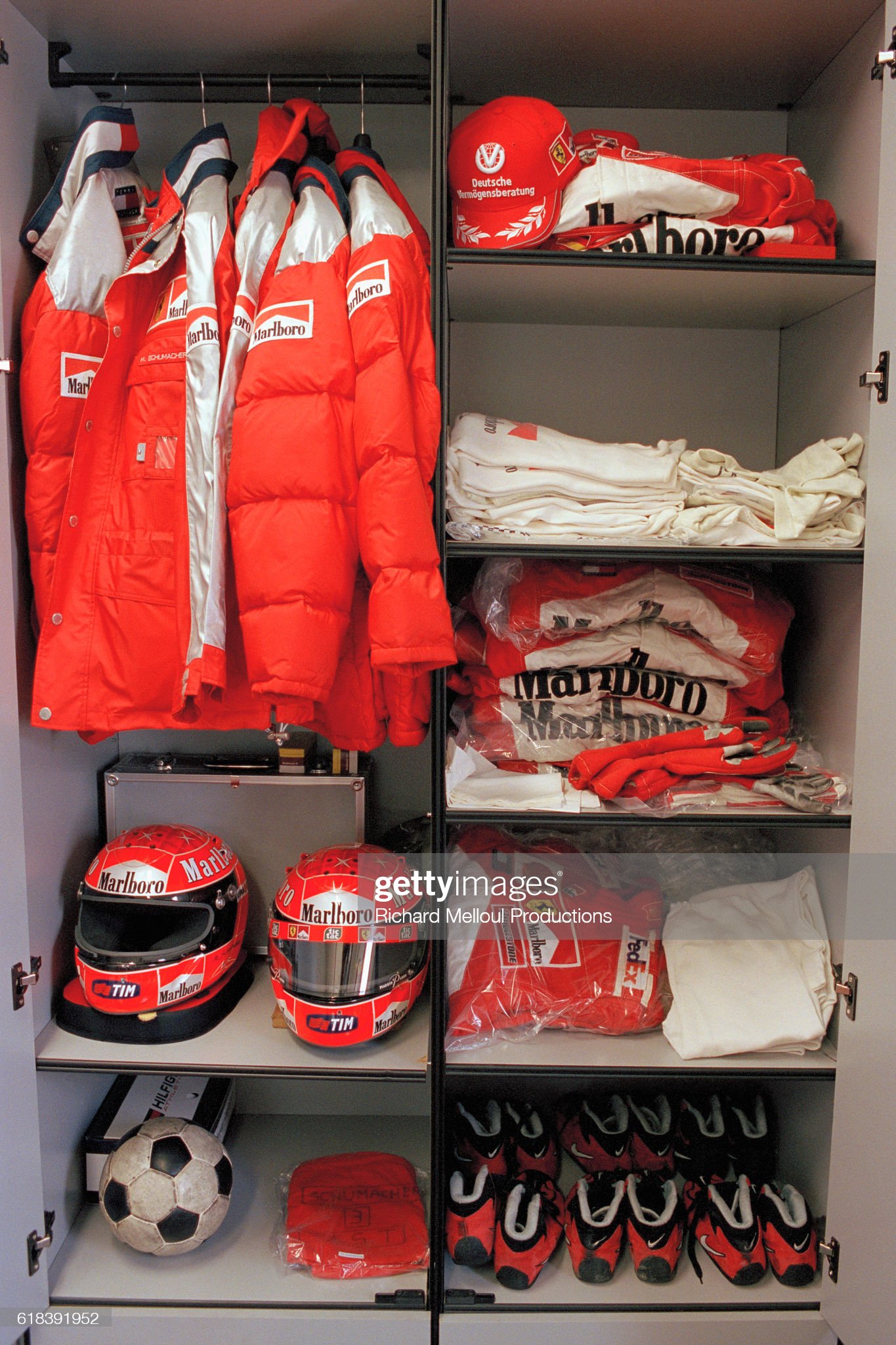 Ferrari Managing Director Jean Todt, not pictured, gives a guided tour behind the scenes at the Ferrari production factory in 2001. Race clothing belonging to Michael Schumacher. 