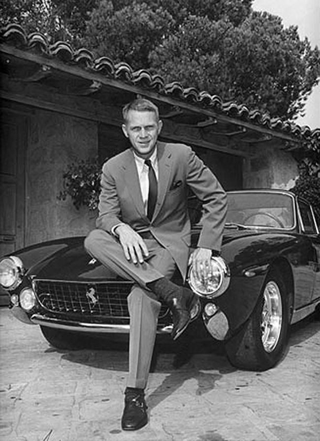 Steve McQueen on a black Ferrari.