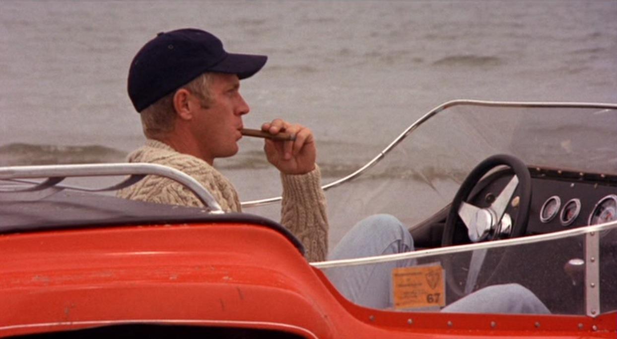 Steve McQueen in an orange Dune Buggy.