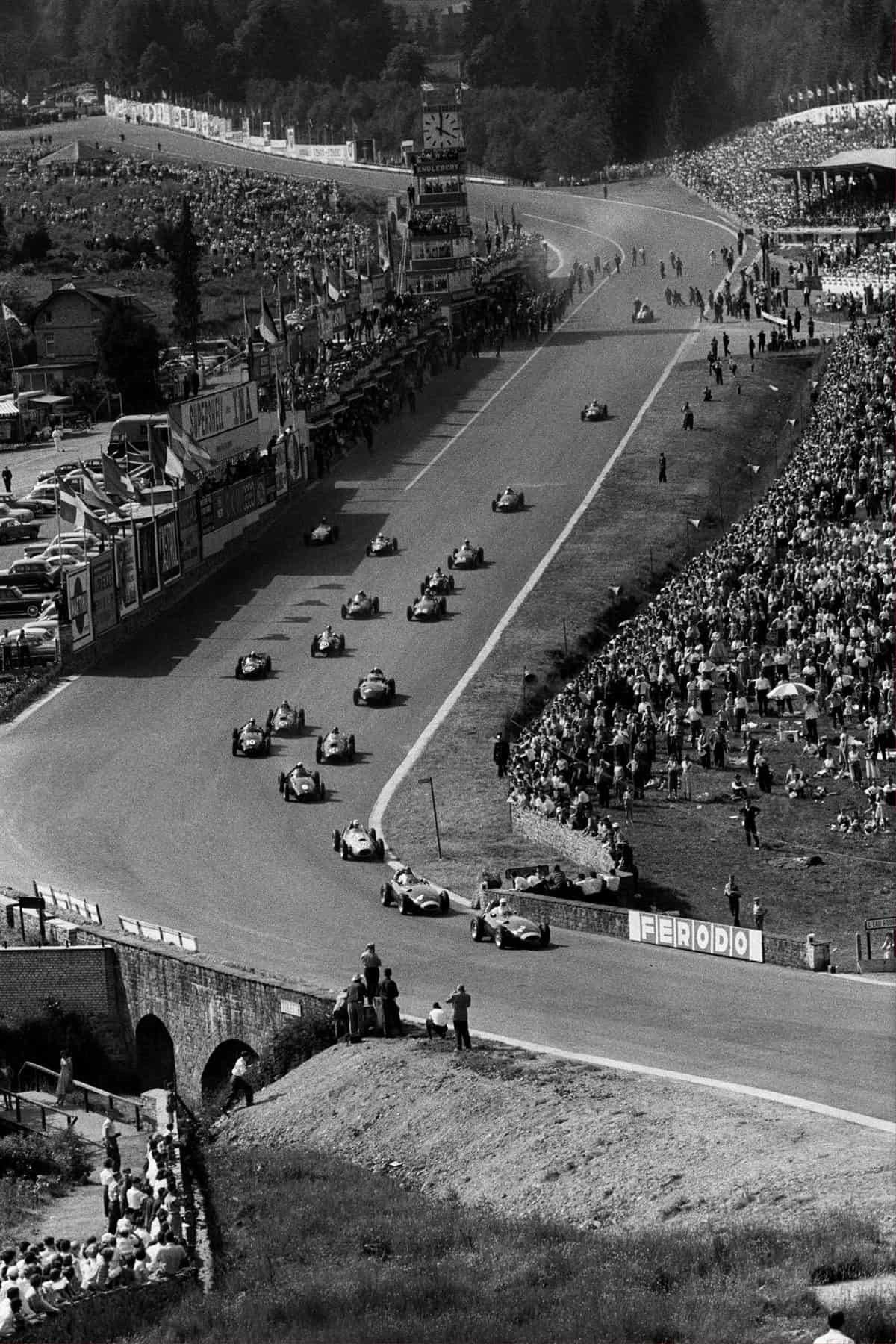 Charging up the hill at Spa-Francorchamps in 1958, en route to the challenging Radillon curve, Moss’ Vanwall leads Tony Brooks and a determined pack of snarling GP cars. 