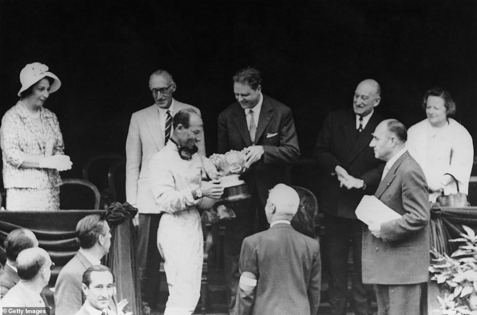 Moss receives his trophy after historically clinching the Monaco GP at Monte Carlo on May 14, 1961.