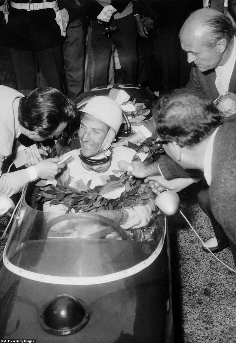 Moss is bombarded by journalists after winning the Monaco Grand Prix - triumphing in his Lotus against the faster Ferraris.