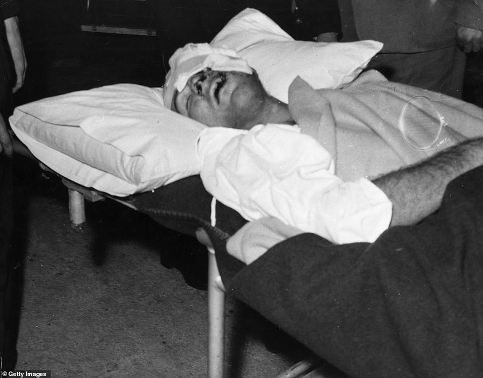 Moss lies unconscious on a stretcher at Atkinson Memorial Hospital, in Wimbledon, after crashing at Goodwood.