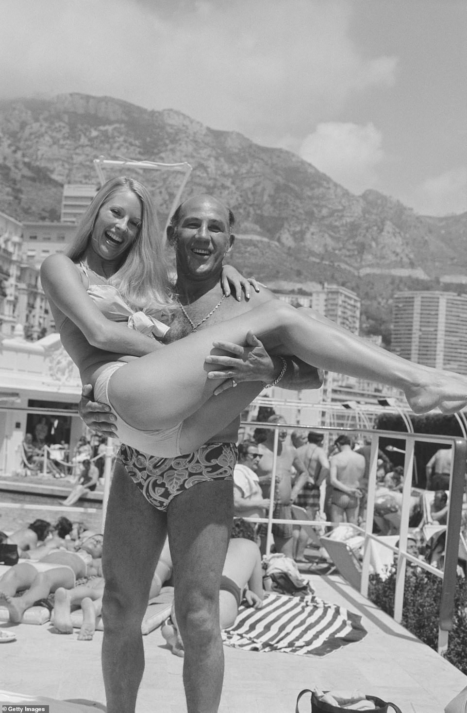 The former driver lifts up fashion model Liz Hooley while on holiday in Monaco back in June 1973.