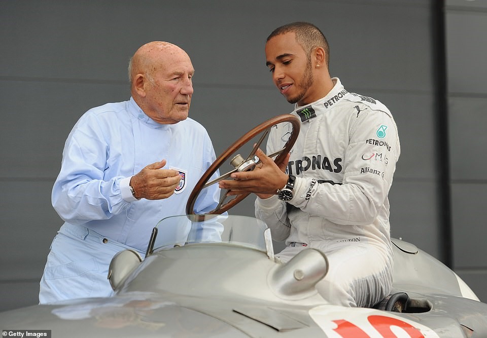 Moss pictured here talking to six-time world champion Lewis Hamilton, back in 2013 at the Silverstone Circuit.