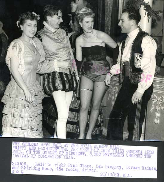 1952 December 31. Chelsea Arts Ball. Stirling Moss with some girls..