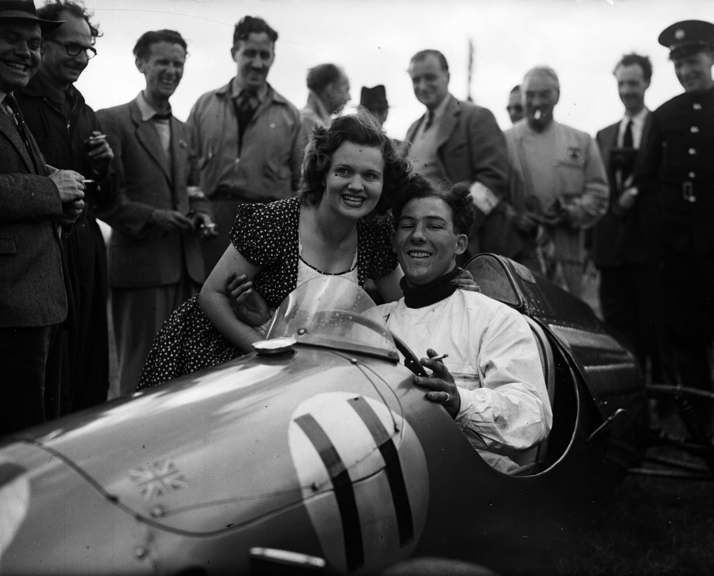 Stirling Moss being congratulated by Mrs. John.
