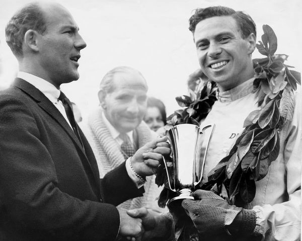 Jim Clark accepts trophy by Stirling Moss in 1962.