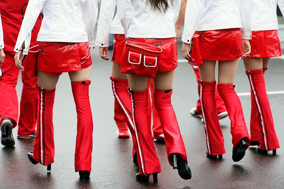 2009, Suzuka, Japan. Practical and fancy solutions for the girl's business clothing during bad weather conditions.