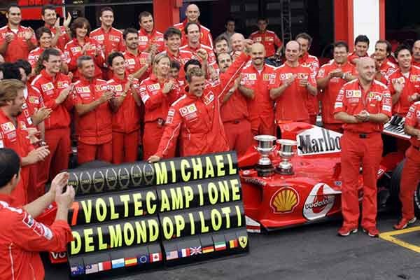 Michael Schumacher celebrates the 2004 title with his team.