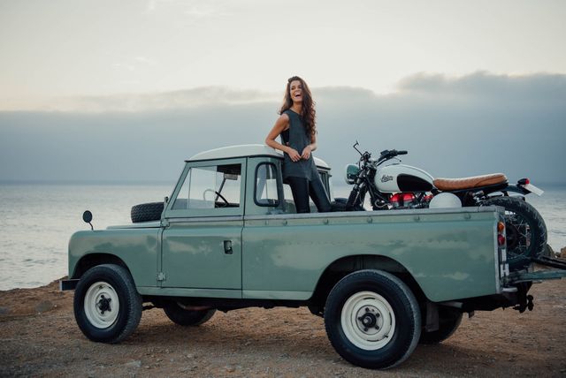 A girl in a Land Rover.