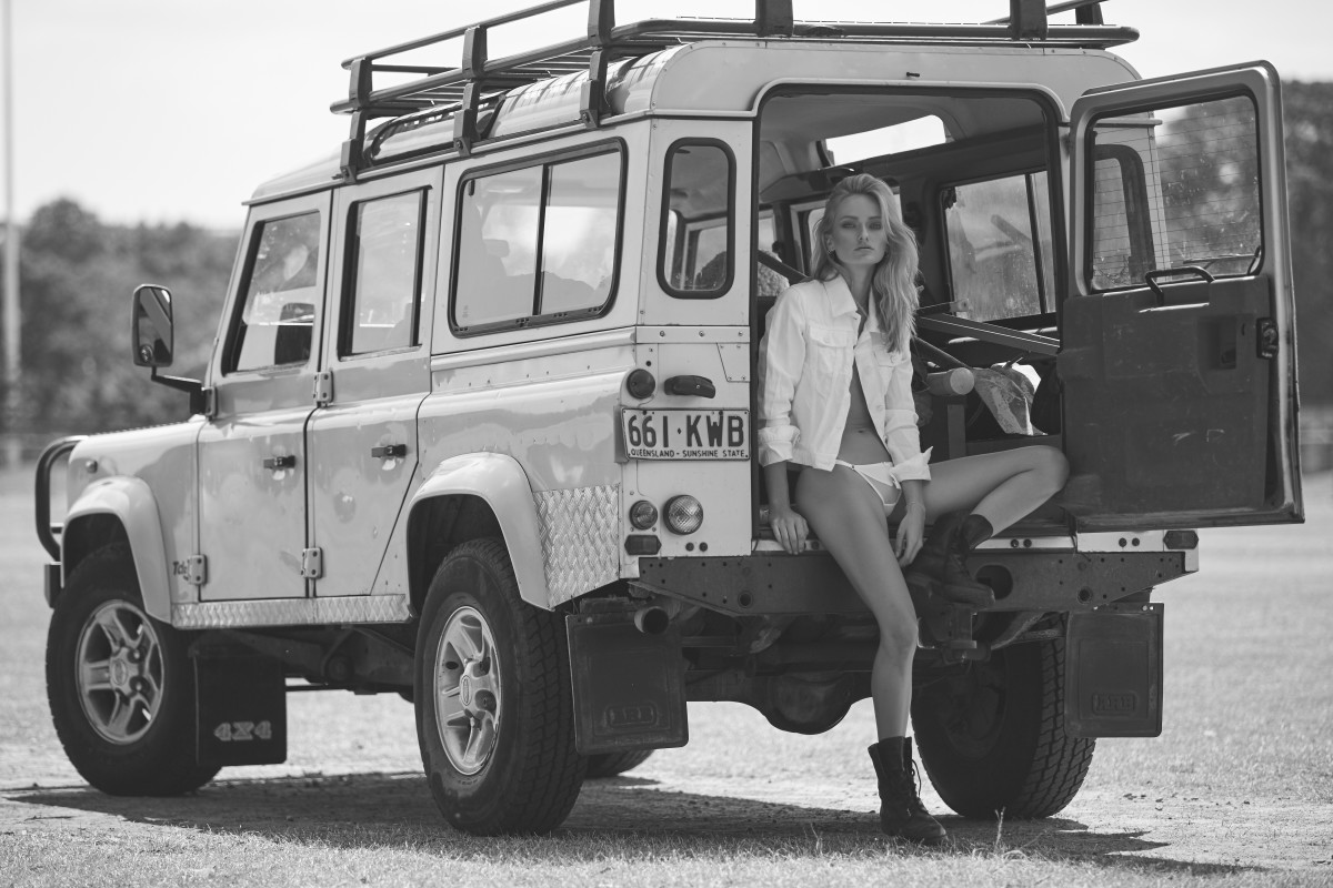 A blonde girl and a white Land Rover.