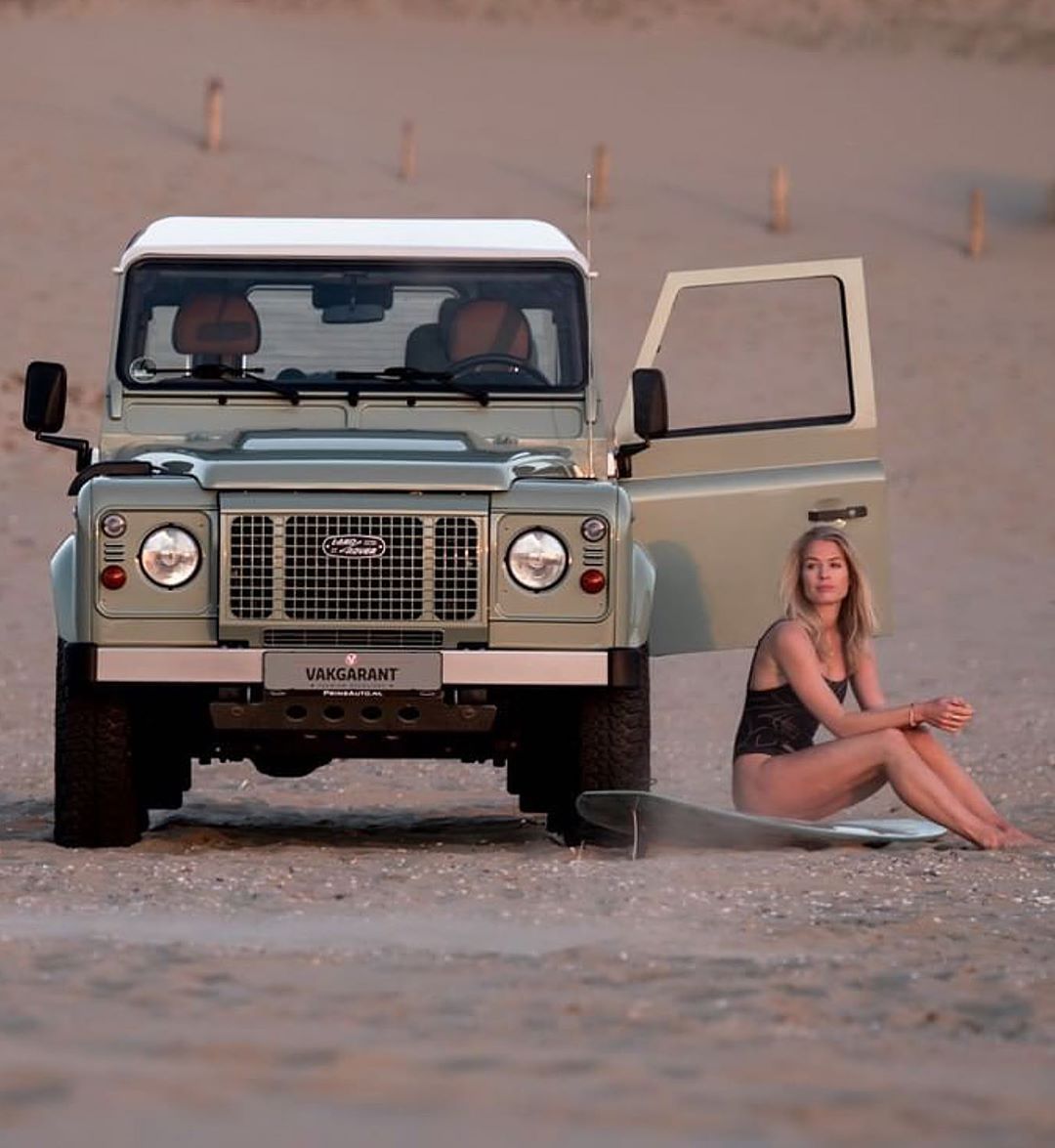 A blond girl and a Land Rover.